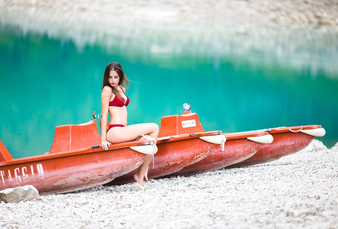 women, sitting, depth of field, red bikinis, sand, water, boat