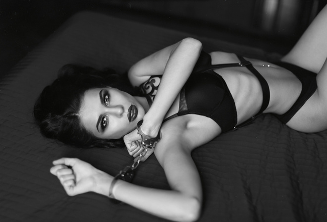 women, belly, black lingerie, pierced navel, armpits, in bed, lying on front, monochrome, handcuffs