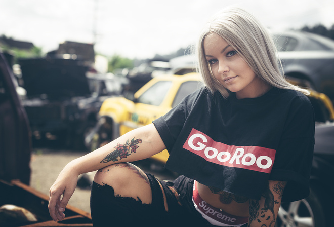 women, blonde, T-shirt, women outdoors, torn jeans, tattoo, portrait, pierced navel, depth of field, lip ring, black clothing