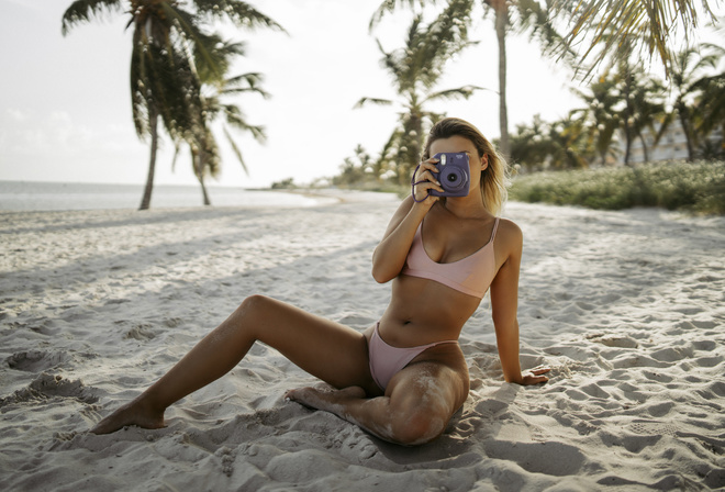 women, blonde, palm trees, tanned, belly, camera, sand, bikini, sand covered, sea, sitting