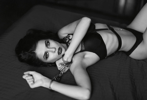 women, belly, black lingerie, pierced navel, armpits, in bed, lying on front, monochrome, handcuffs