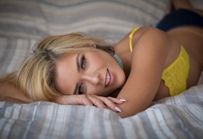 Neesy Rizzo, women, blonde, smiling, lying on front, in bed, yellow bra, lingerie, tanned, pierced nose, gray eyes, choker