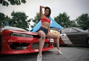 women, tanned, jean shorts, red tops, tattoo, car, women outdoors, sneakers, sitting, pierced navel, armpits