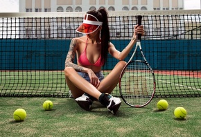 women, sitting, grass, tattoo, bikini top, tennis rackets, tennis balls, jean shorts, tanned, sneakers, painted nails, legs crossed