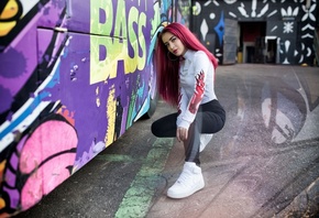 women, dyed hair, portrait, sneakers, squatting, red nails, jeans, eyeliner