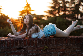 women, Marco Squassina, sunset, bricks, jean shorts, women outdoors, lying on front