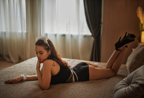 women, high heels, painted nails, in bed, pillow, Black clothes, finger on lips, tattoo, window, women indoors, feet in the air, lying on front, curtains, lamp, nose ring, closed eyes, hair bows