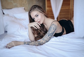 women, black lingerie, ass, in bed, women indoors, tattoo, lying on front, pillow, blue eyes, finger on lips