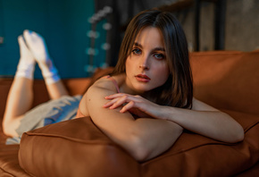 women, skirt, couch, feet in the air, white stockings, face, arms crossed, women indoors, lying on front