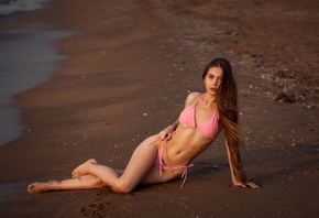 women, pink bikini, long hair, sand, sea, belly, ribs, crucifix necklace, women outdoors, hips, pink nails, sand covered body, sitting