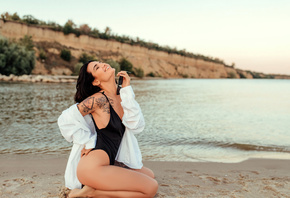 women, kneeling, sand, sunglasses, smiling, one-piece swimsuit, sea, tattoo, white shirt, women outdoors, closed eyes