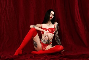 women, studio, red lingerie, skinny, women indoors, red panties, tattoo, belly, ribs, see-through lingerie, red lipstick, necklace, sitting, black hair, red stockings, nose ring, painted nails