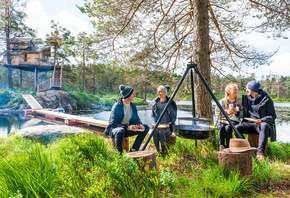 Southern Norway, summer, friends eating around a bonfire, Treetop Cabin, Lyngdal