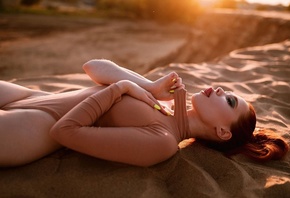 redhead, women, model, women outdoors, bodysuit, hips, tongue out, hips, sunset, closed eyes, sand