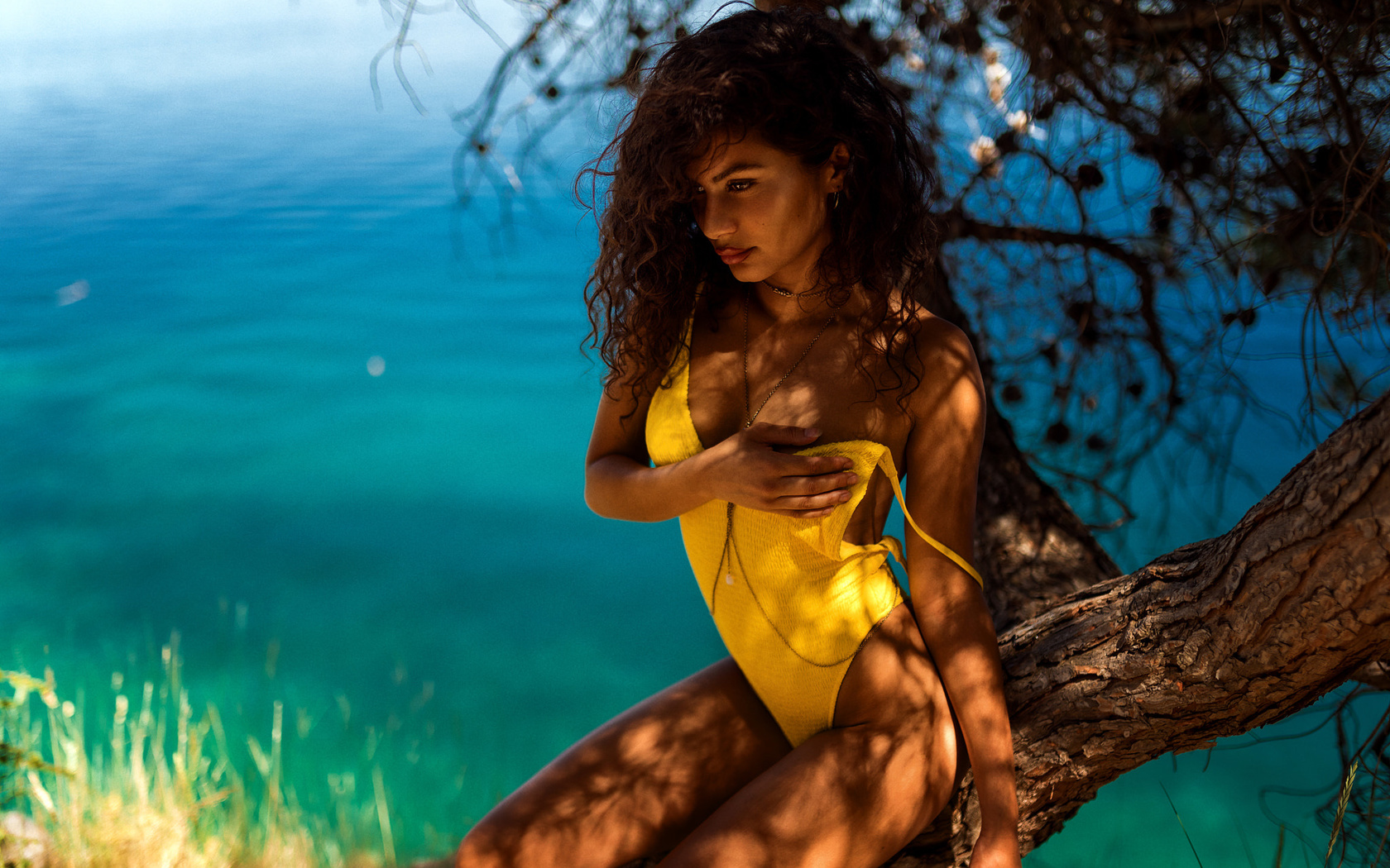 women, miro hofmann, tanned, sitting, hands on boobs, water, curly hair, one-piece swimsuit, trees