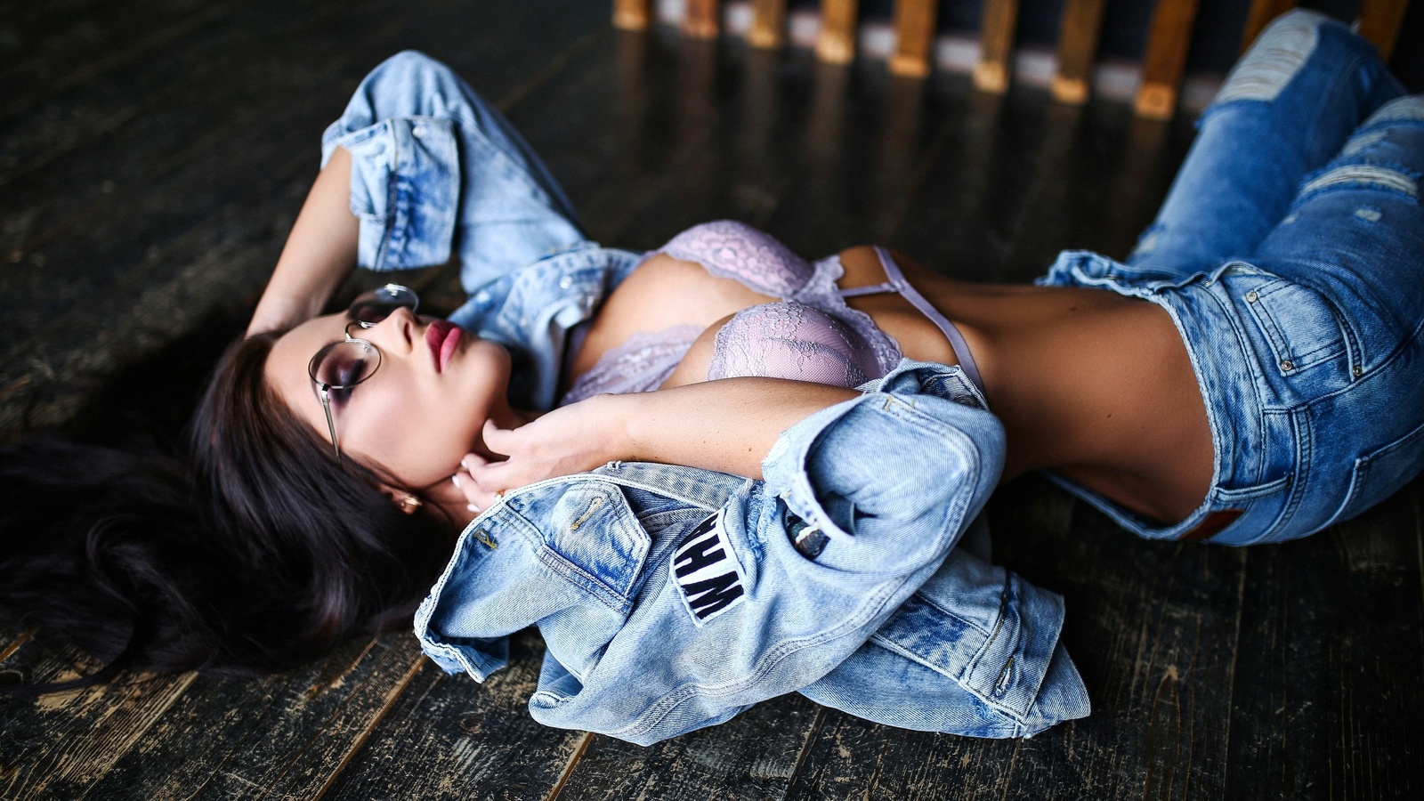 women, purple bra, torn jeans, denim, women with glasses, tanned, wooden surface, closed eyes, belly, pink lipstick, lying on back