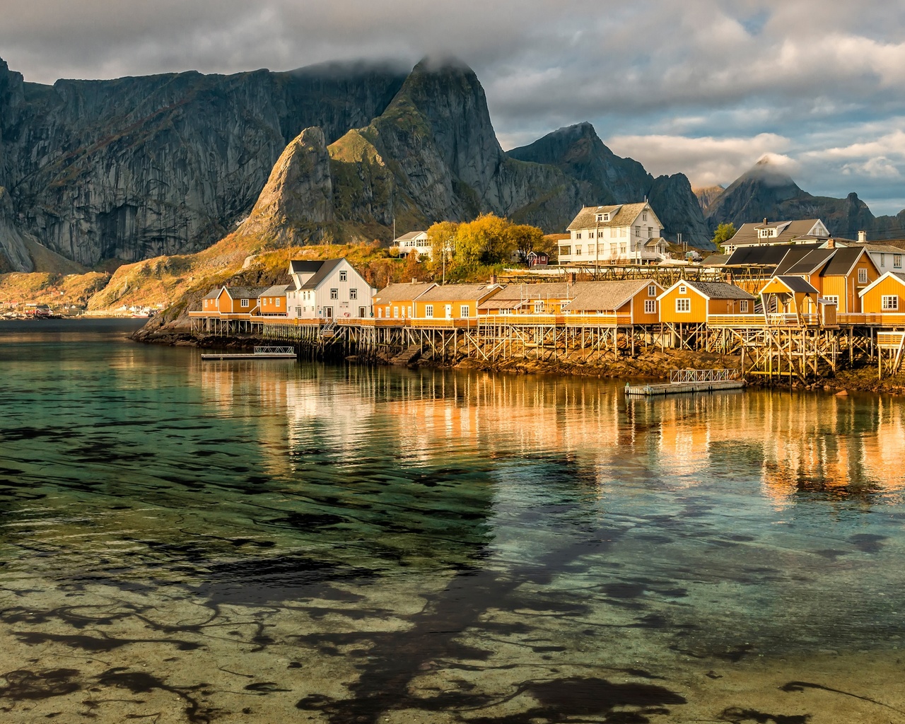 the sky, water, clouds, reflection, landscape, mountains, nature, rocks, shore, tops, the bottom, boats, norway, houses, pond, the village, piles, the lofoten islands