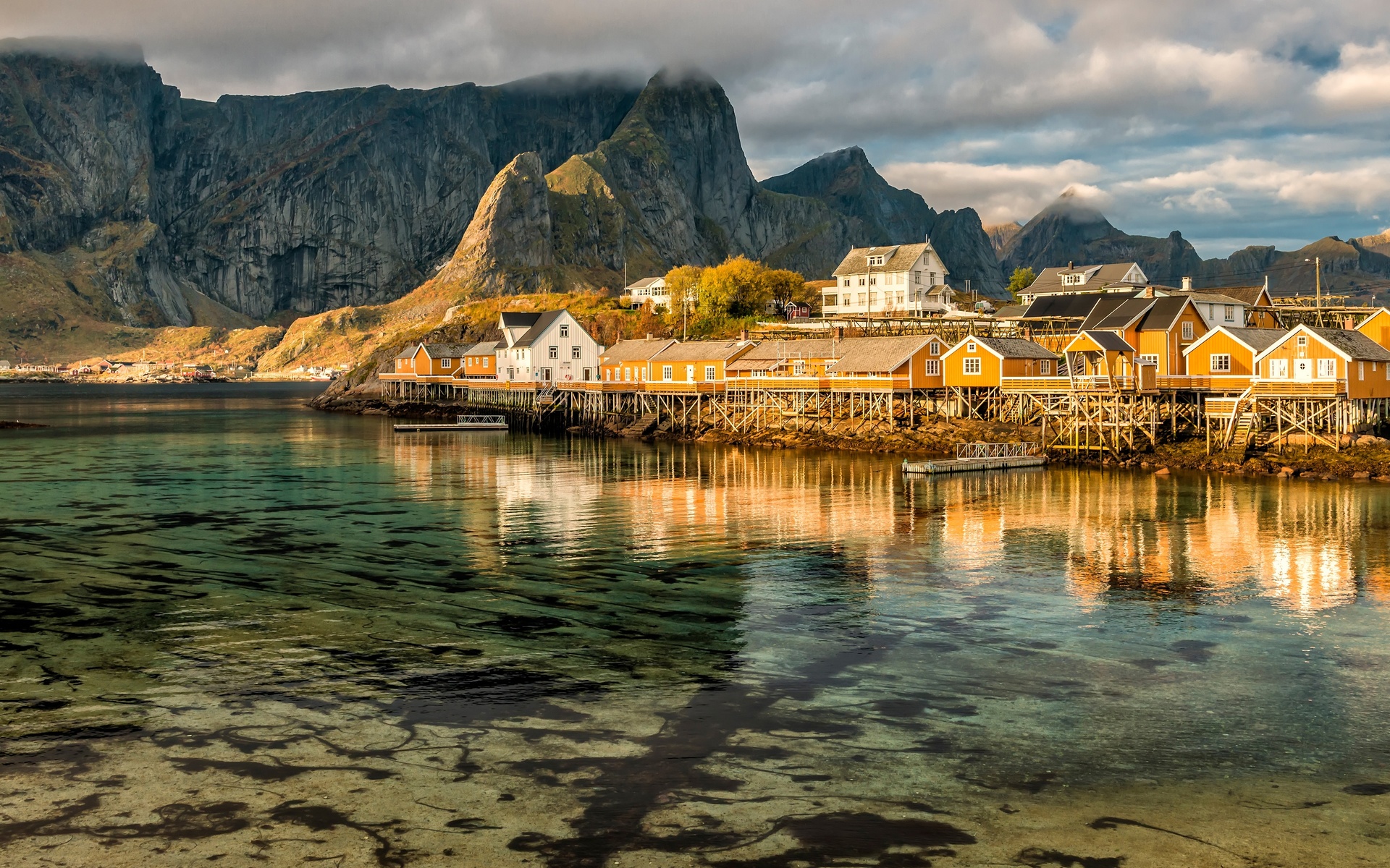 the sky, water, clouds, reflection, landscape, mountains, nature, rocks, shore, tops, the bottom, boats, norway, houses, pond, the village, piles, the lofoten islands
