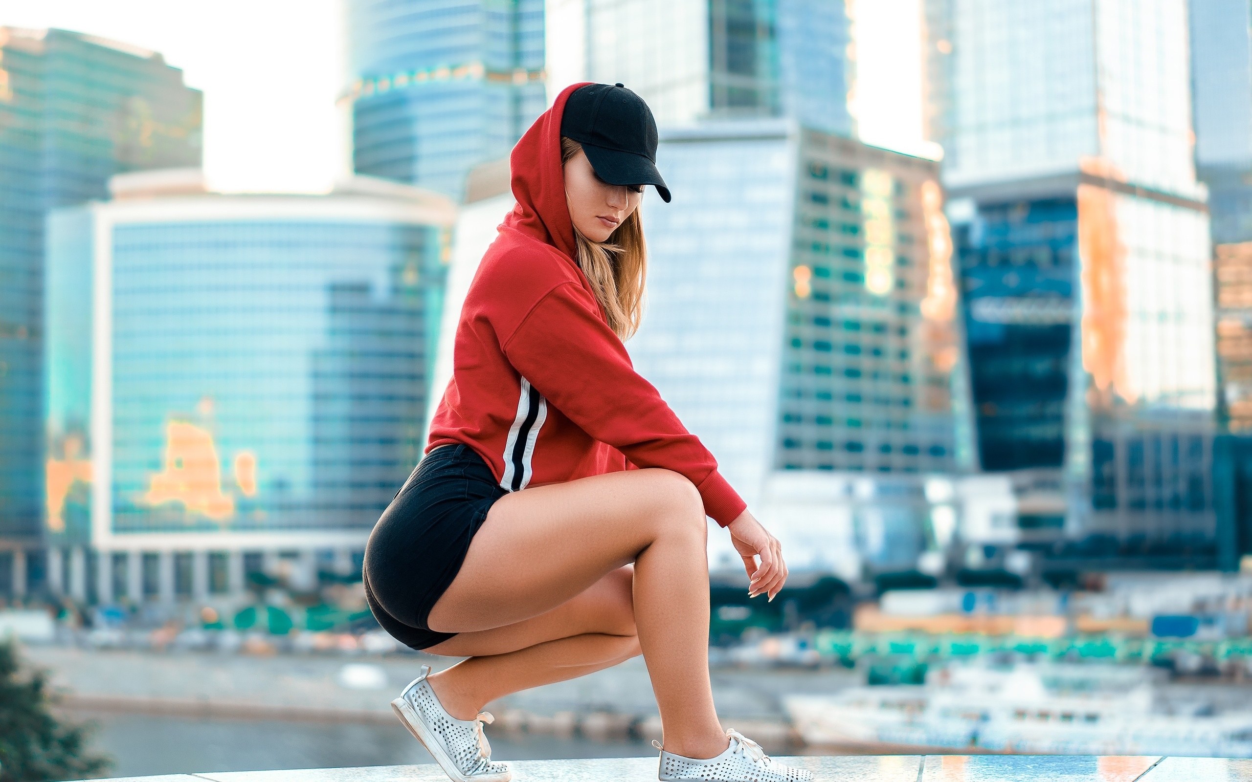 women, blonde, sweater, building, squatting, baseball cap, ass, sneakers, hoods