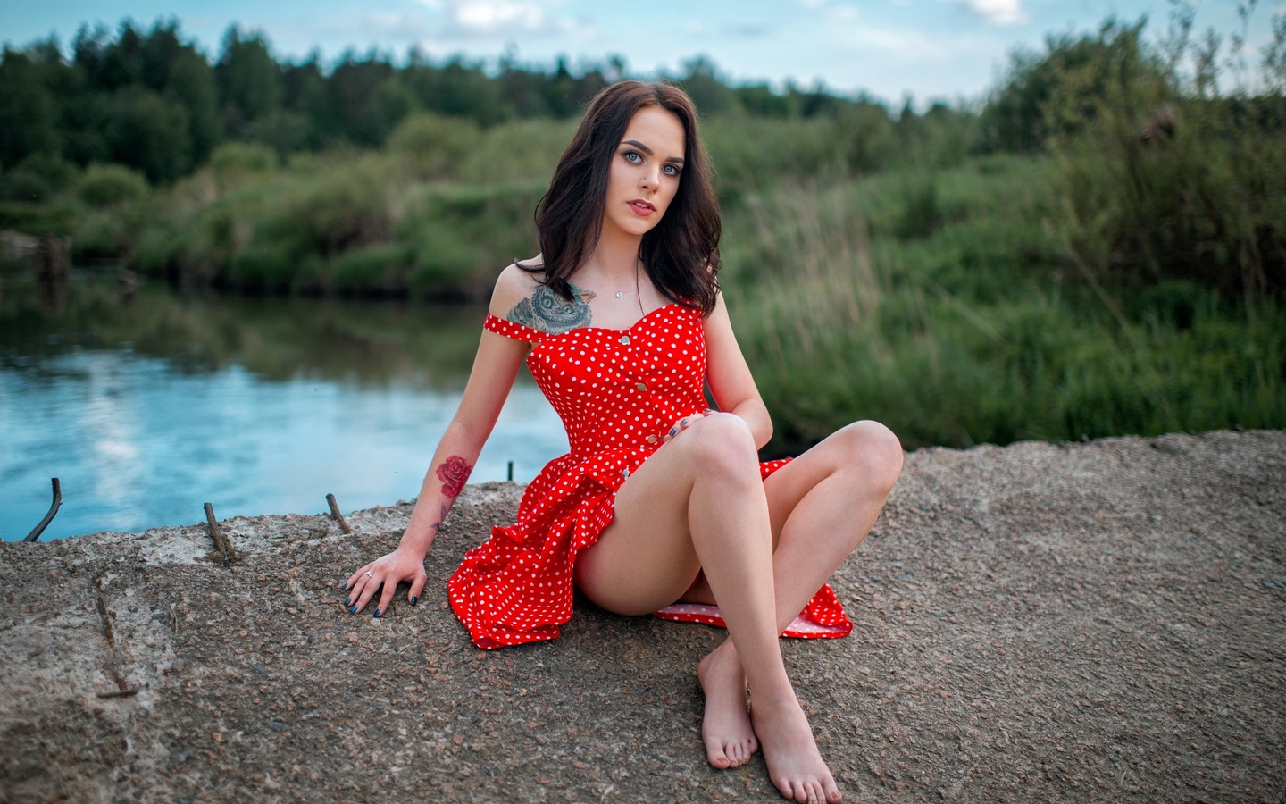 women, red dress, polka dots, women outdoors, tattoo, sitting, ass, blue nails, river, bare shoulders, pierced nose, gray eyes, red lipstick