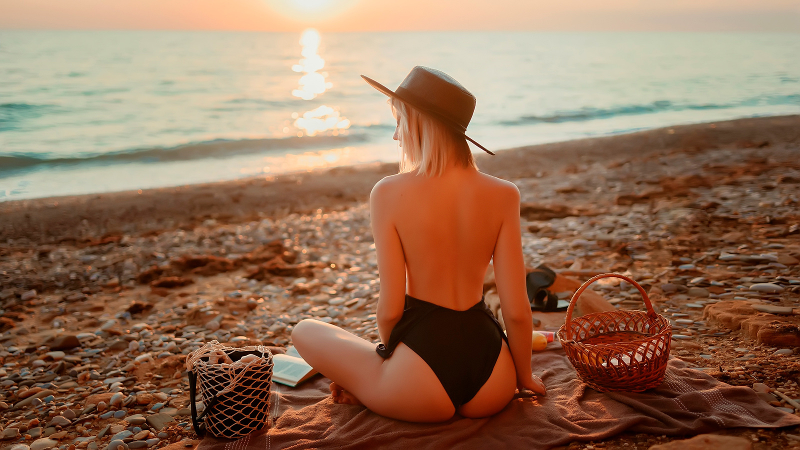 women, blonde, brunette, one-piece swimsuit, ass, sunset, sea, beach, women outdoors, black swimsuit, back, books, hat, sitting