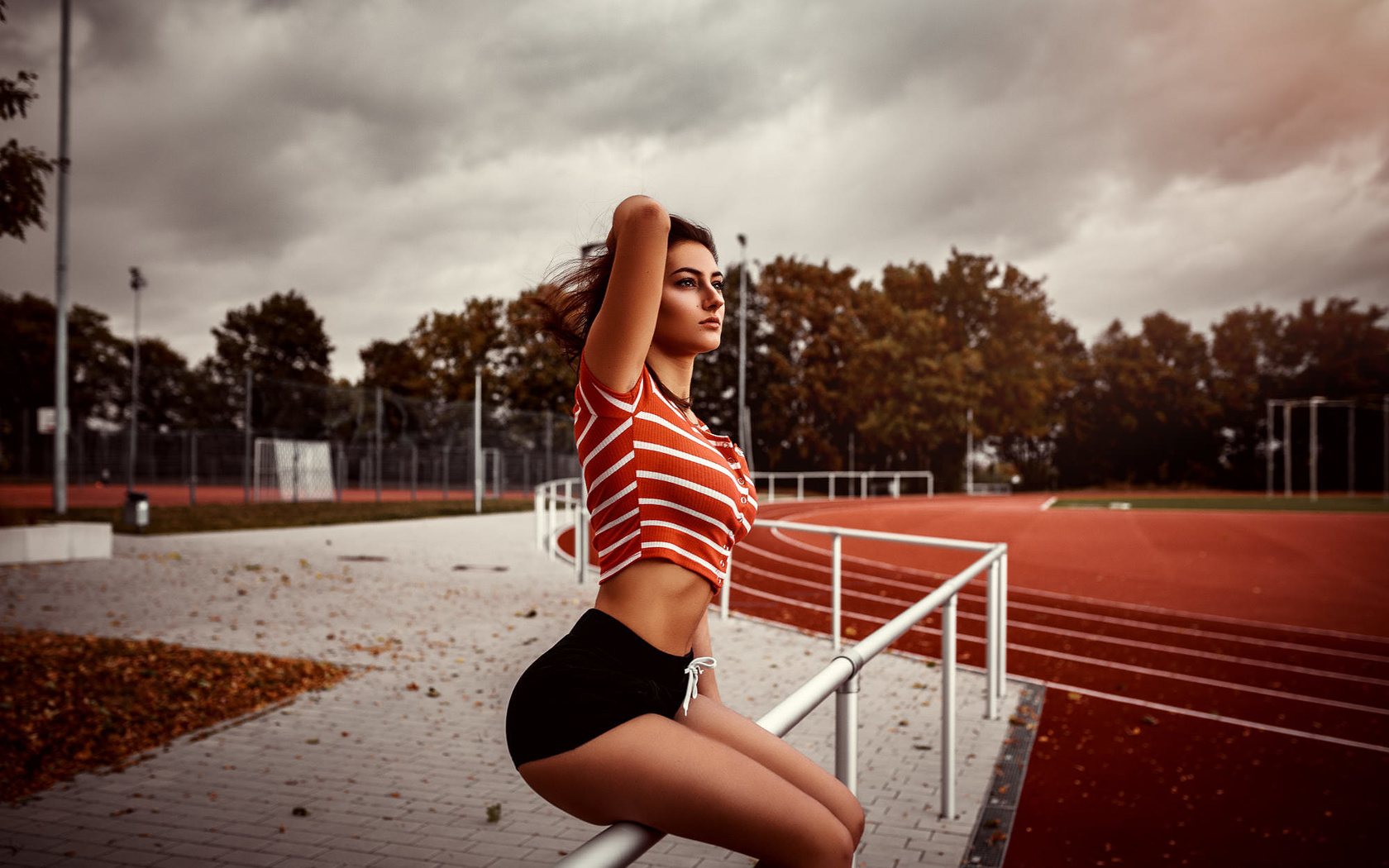 women, sitting, high waisted short, ass, trees, women outdoors, crop top, looking away, leaves, fence, belly, clouds, sky