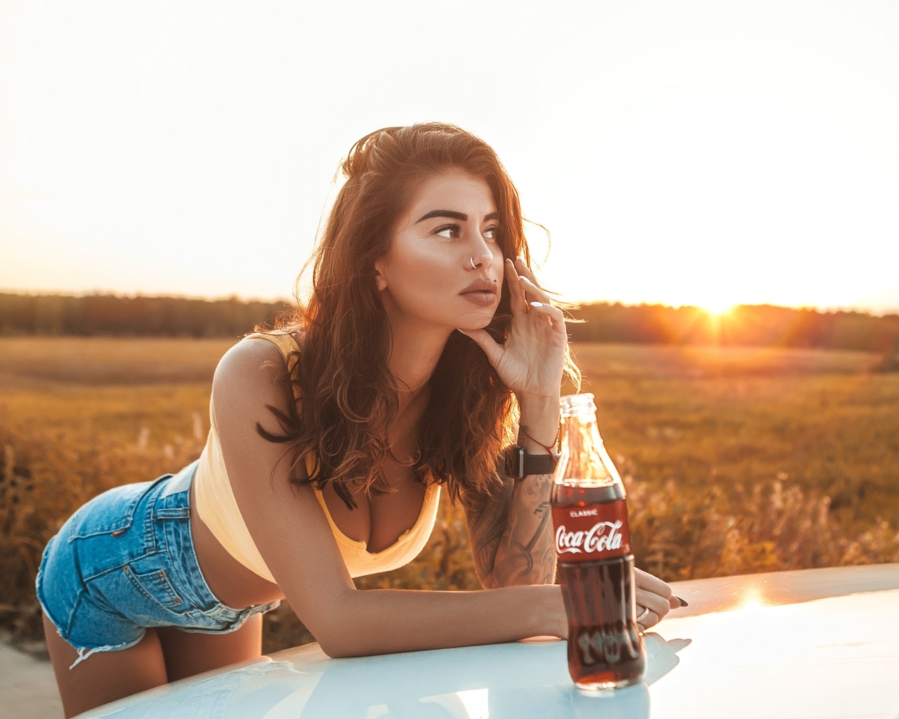 women, brunette, women outdoors, women with cars, nose ring, jean shorts, bottles, coca-cola, piercing, looking away, juicy lips, sunset, tank top, tattoo, watch