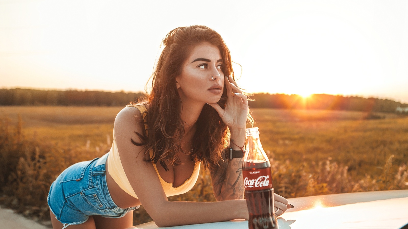 women, brunette, women outdoors, women with cars, nose ring, jean shorts, bottles, coca-cola, piercing, looking away, juicy lips, sunset, tank top, tattoo, watch