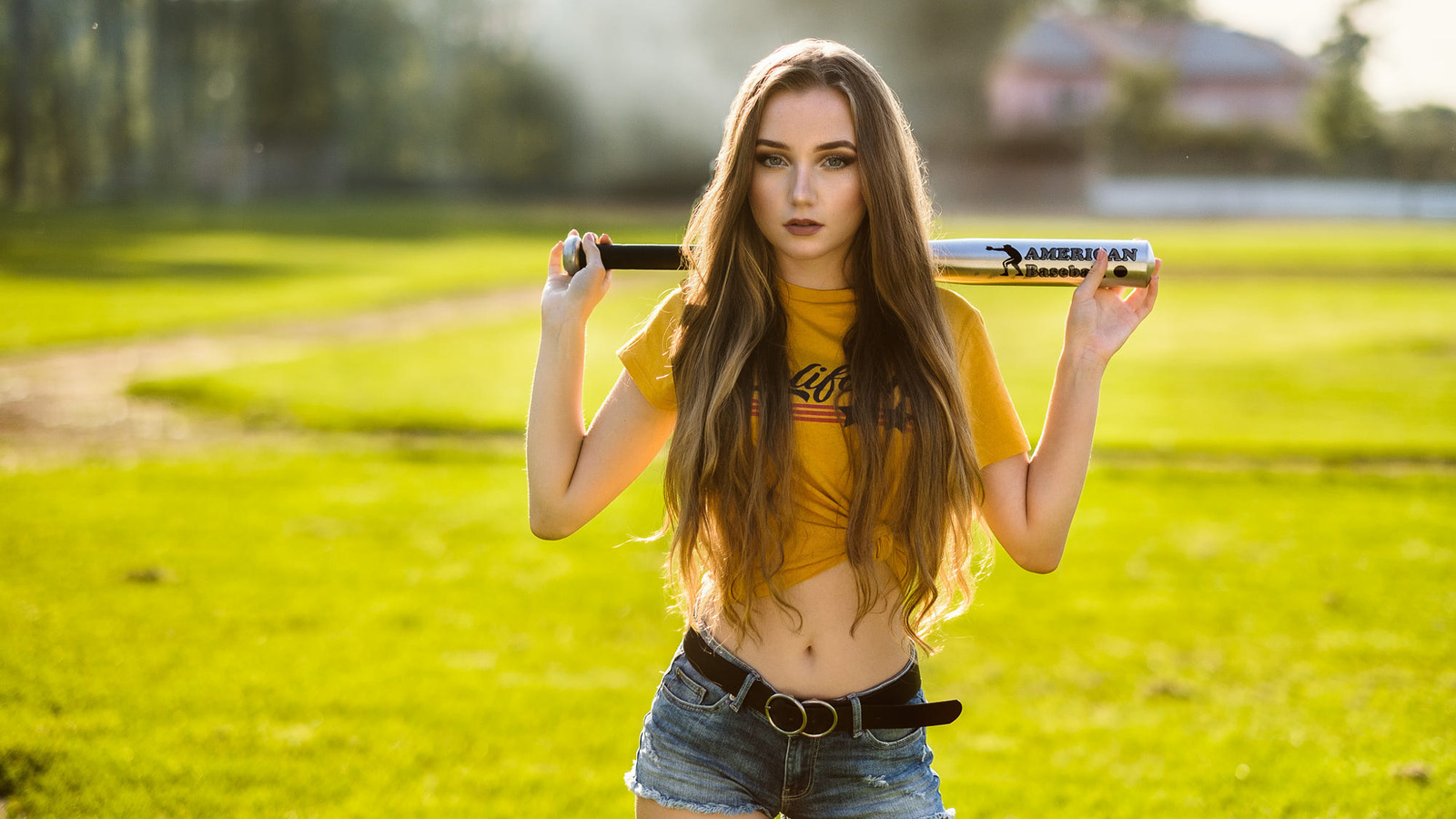 women, yellow t-shirt, belly, grass, long hair, belt, jean shorts, women outdoors, baseball bat