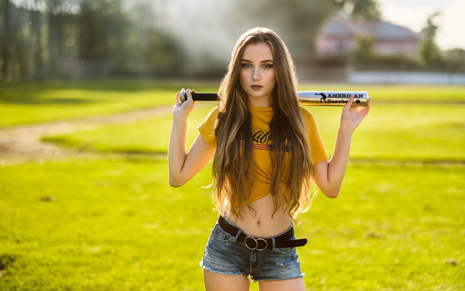 women, yellow t-shirt, belly, grass, long hair, belt, jean shorts, women outdoors, baseball bat