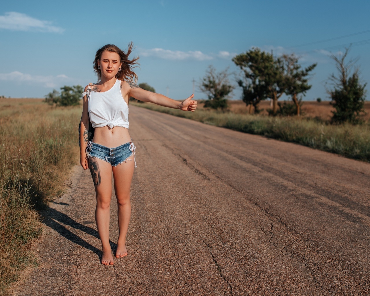 women, handbags, blonde, jean shorts, road, women outdoors, tank top, belly, sky, clouds, tattoo, hips, brunette, trees