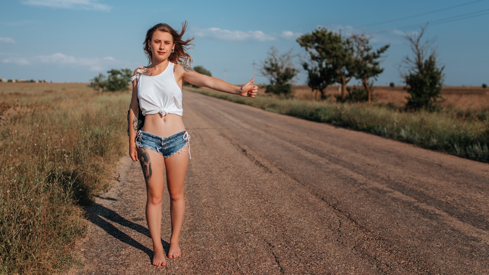 women, handbags, blonde, jean shorts, road, women outdoors, tank top, belly, sky, clouds, tattoo, hips, brunette, trees