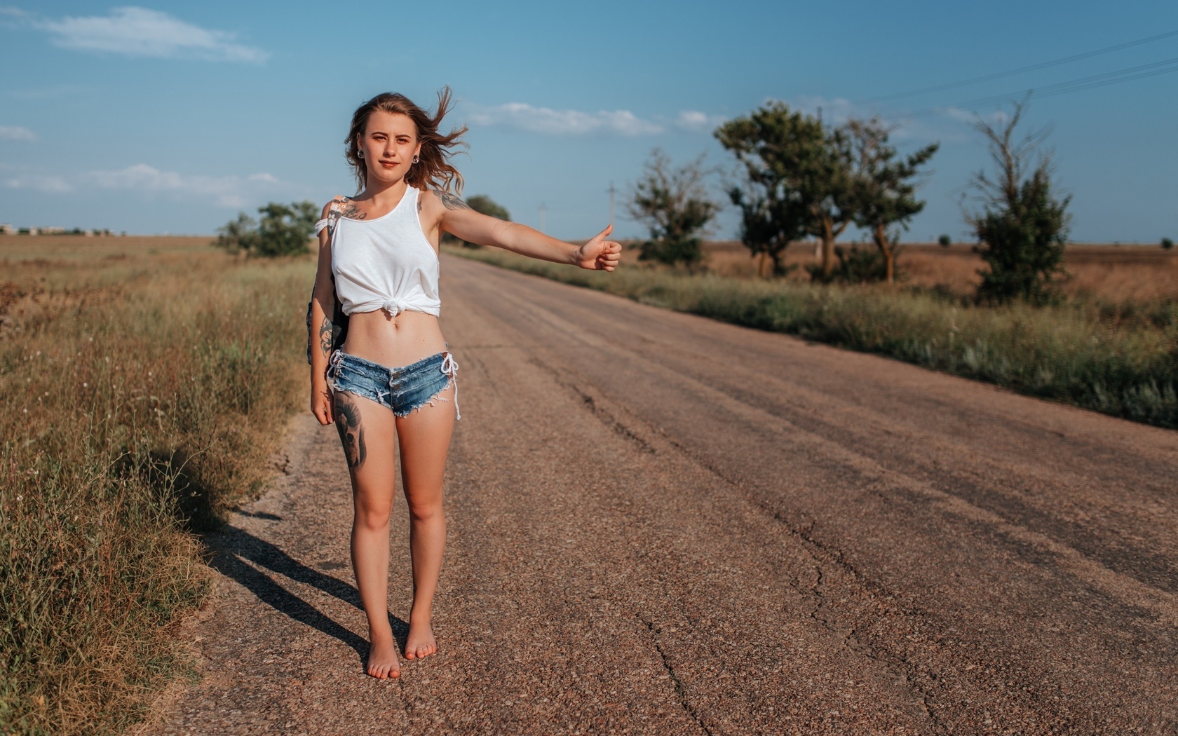 women, handbags, blonde, jean shorts, road, women outdoors, tank top, belly, sky, clouds, tattoo, hips, brunette, trees