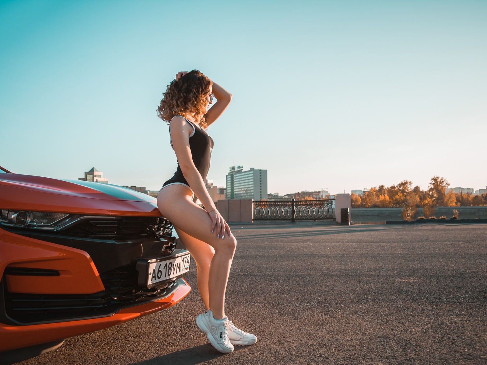 women, women with cars, ass, sneakers, fila, bodysuit, curly hair, women with glasses, sky, building, women outdoors, chevrolet