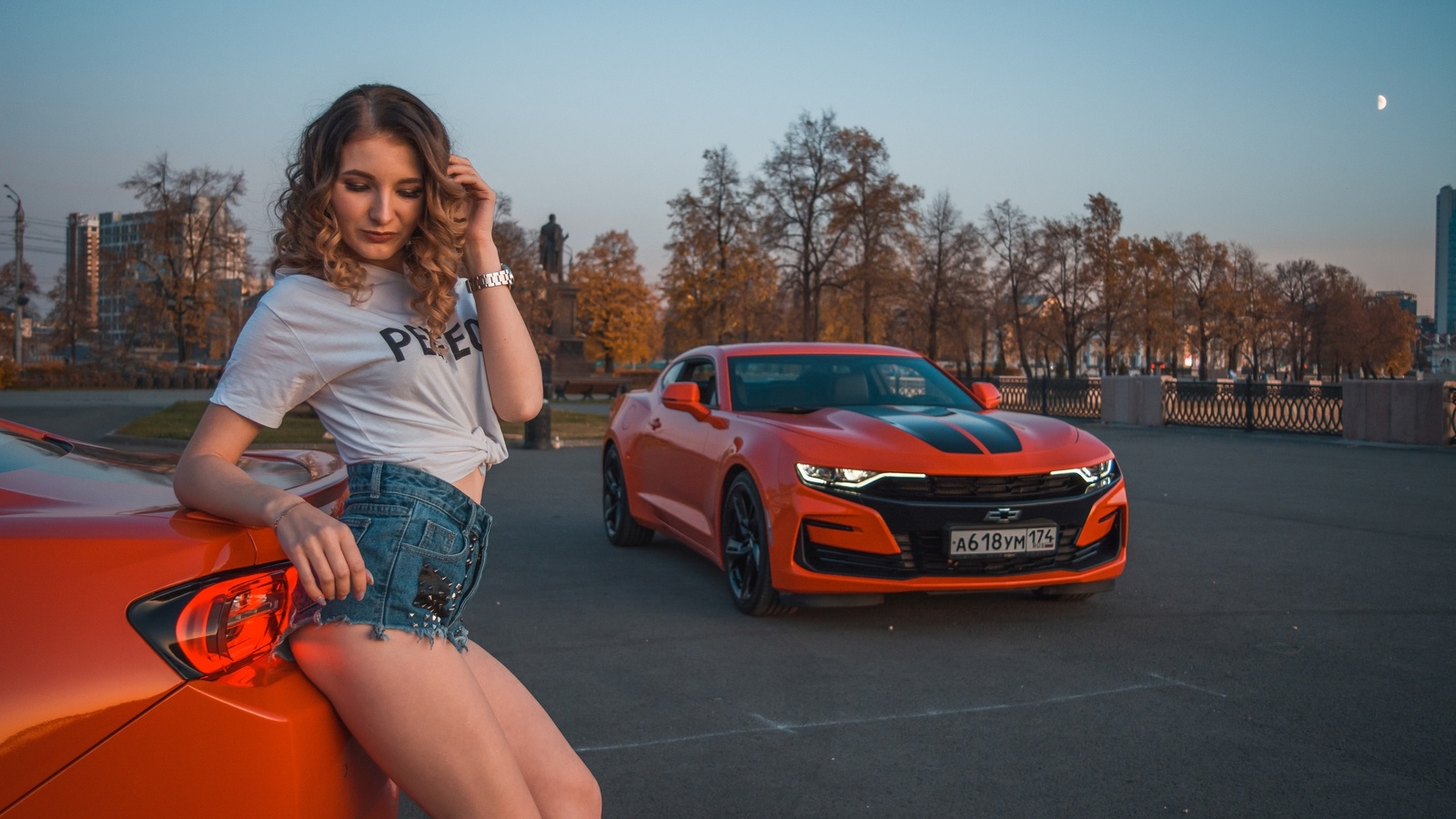 women, women with cars, curly hair, trees, sky, women outdoors, building, white t-shirt, watch, moon, chevrolet