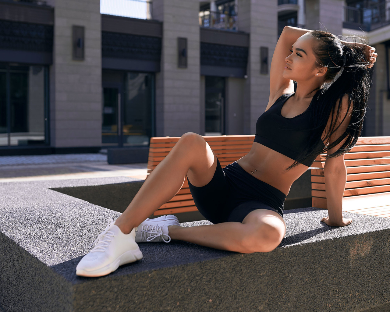 women, sportswear, brunette, exercise, women outdoors, black clothing, belly, pierced navel, sneakers, long hair, bench, ponytail, black top, looking away