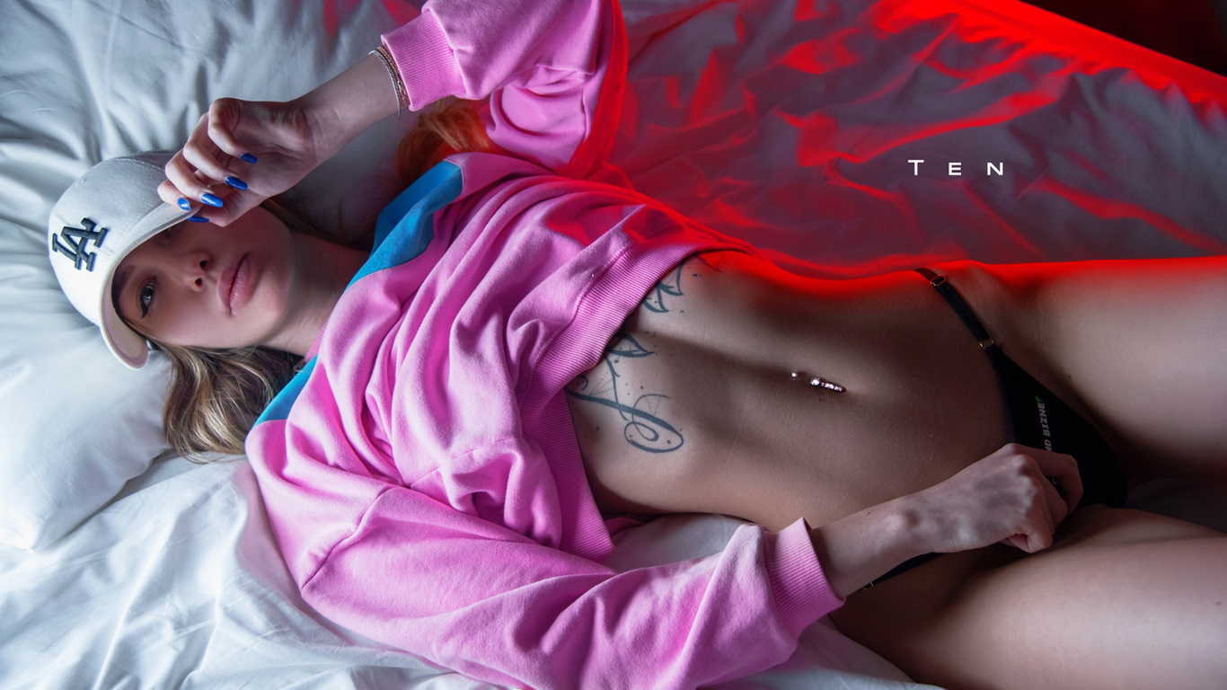 women, alexander ten, baseball cap, black panties, tattoo, in bed, pink lipstick, pink sweater, blue nails, belly, pierced navel, top view, hips