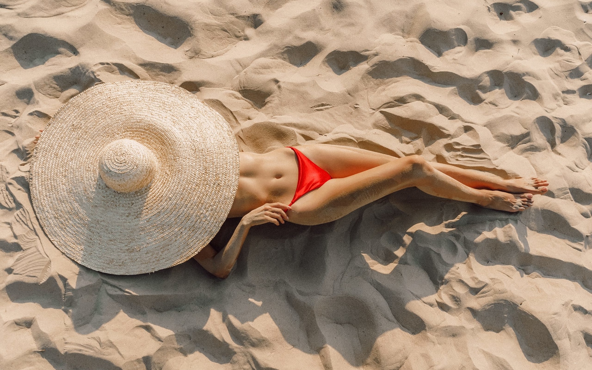 women, top view, hat, red bikini, sand covered, belly, women outdoors, lying on back, sand