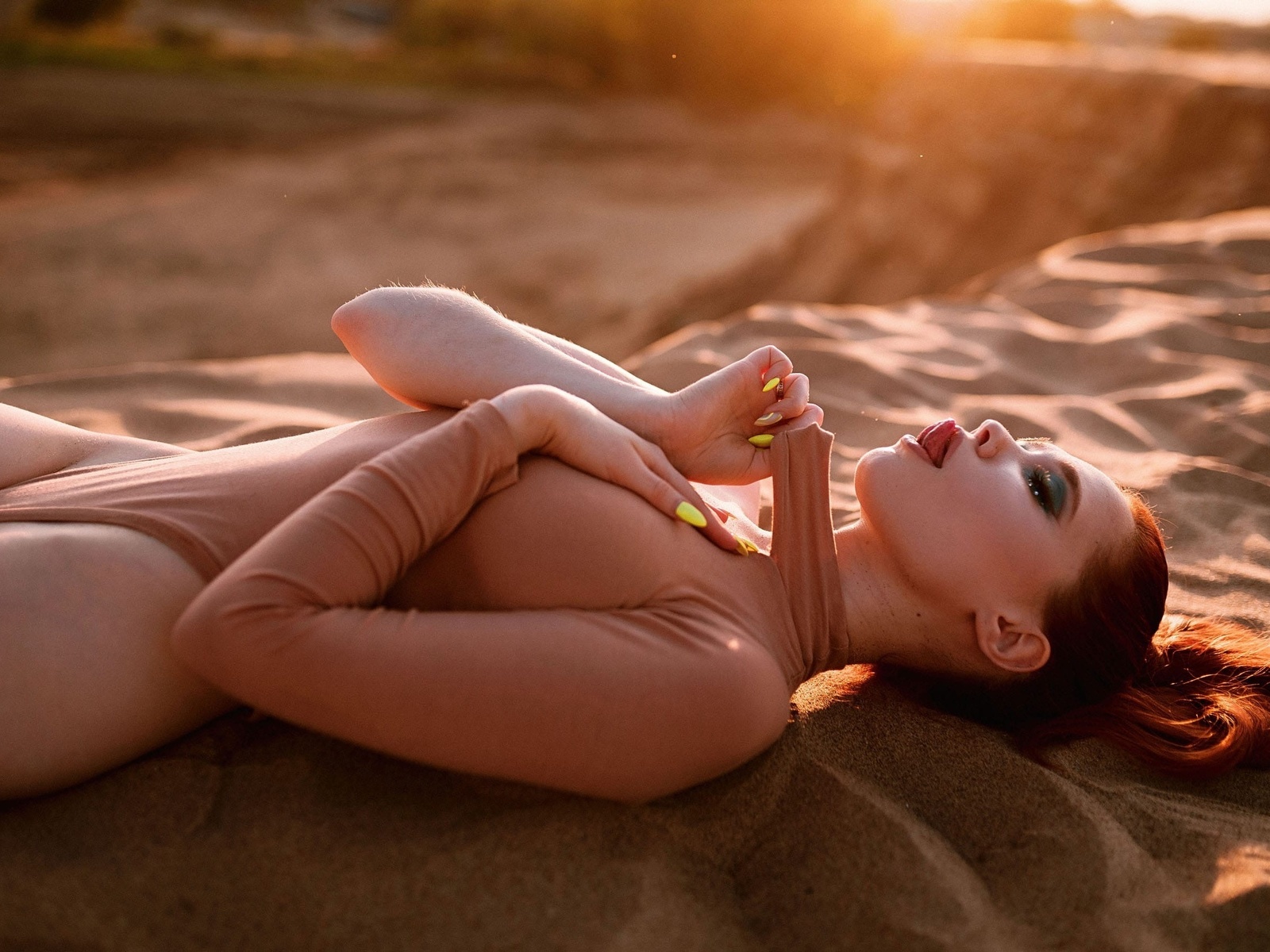 redhead, women, model, women outdoors, bodysuit, hips, tongue out, hips, sunset, closed eyes, sand