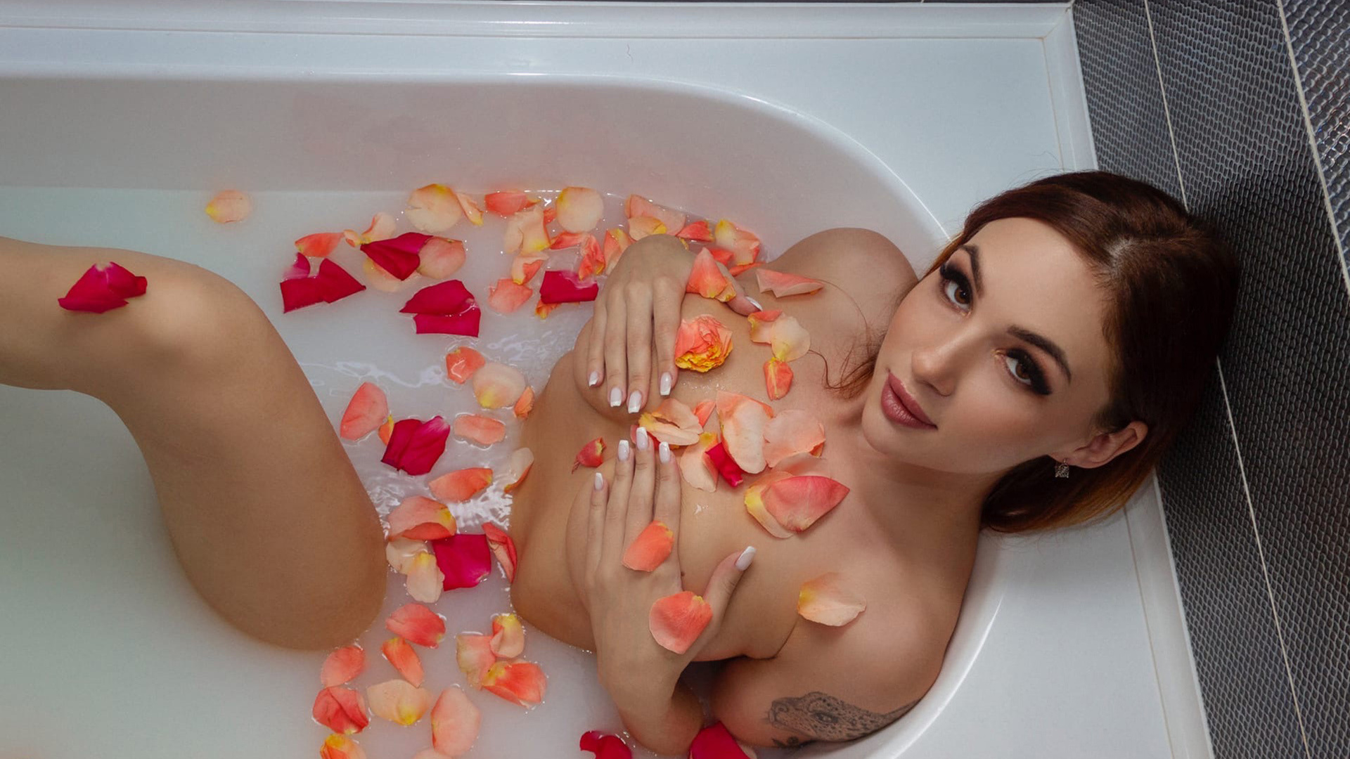 petals, bathtub, redhead, tattoo, , women incoors, red lipstick, women, brown eyes, white nails, model, in bathtub, nude, covering boobs