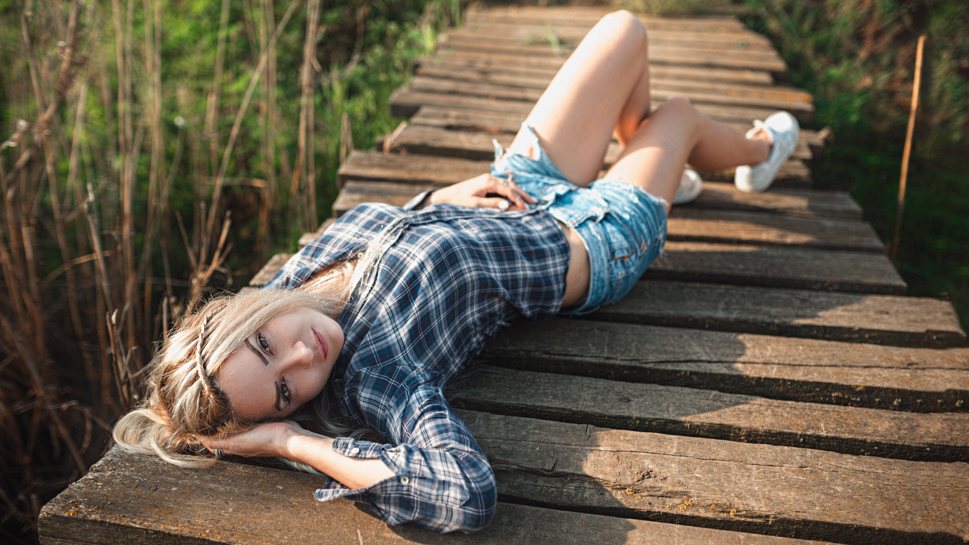 jean shorts, road, blonde, wooden surface, walkway, women outdoors, sneakers, women, , plaid shirt, lying on back, model